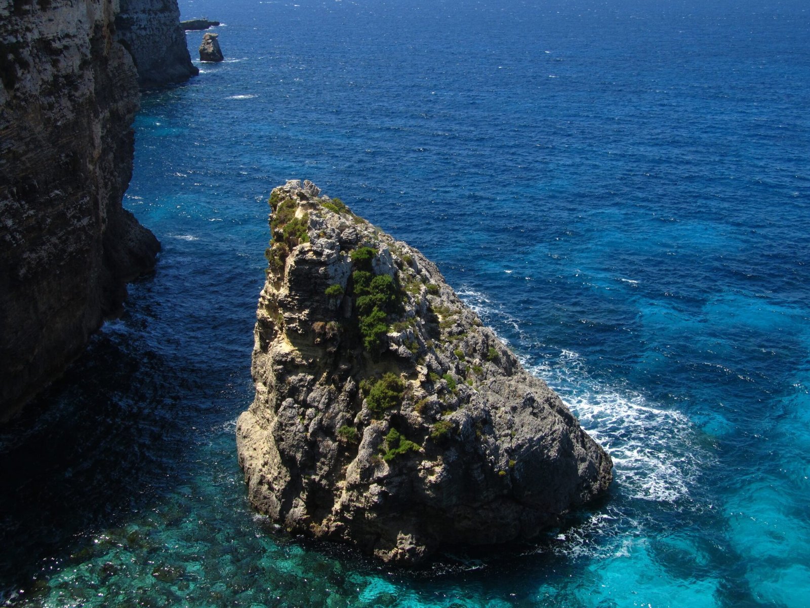 rocks-coastline-comino-malta-surrounded-by-water-min-2048x1536